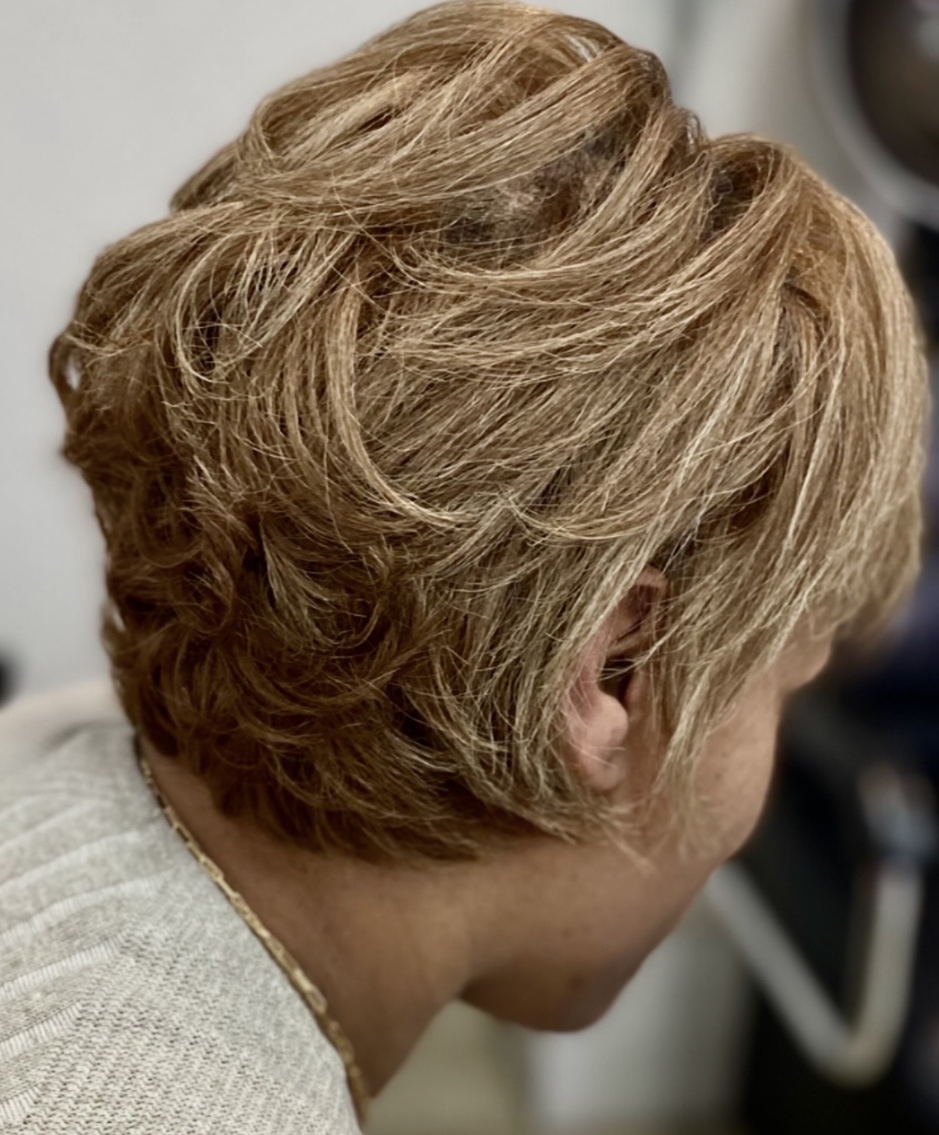 Blonde layered haircut at Genetik Bleu Salon